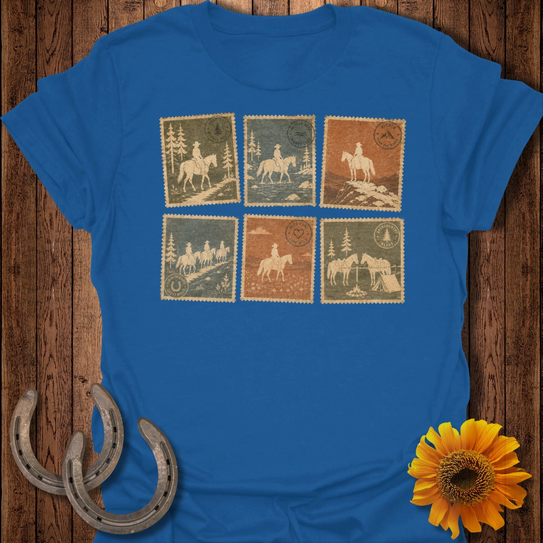 Blue t-shirt featuring six vintage-style postage stamp illustrations of cowboys on horseback.