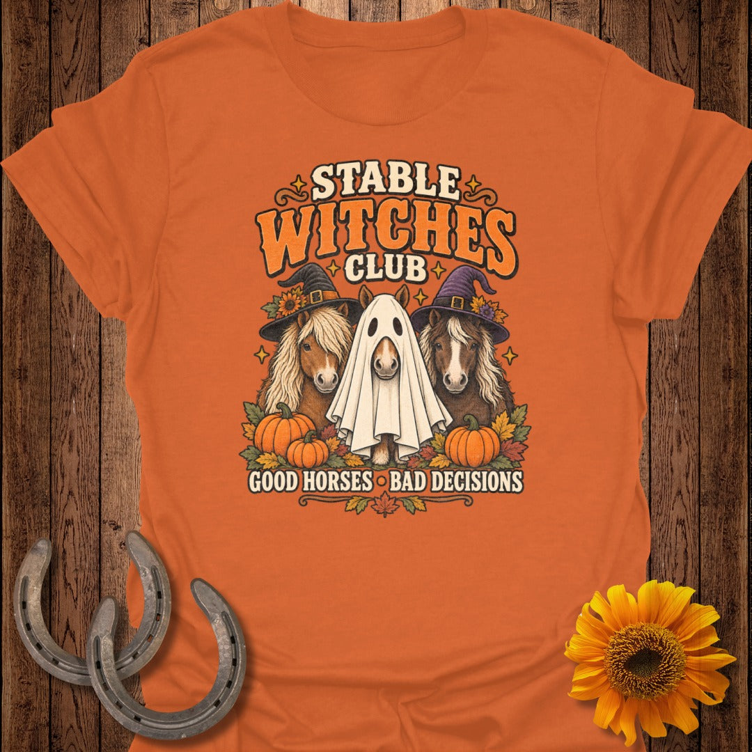 Orange t-shirt with "Stable Witches Club" text, three horses, and pumpkins.