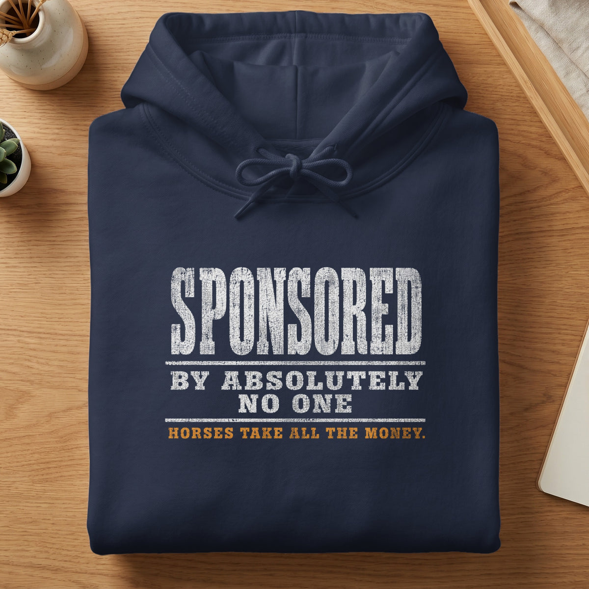Navy blue hoodie with distressed text: "SPONSORED BY ABSOLUTELY NO ONE HORSES TAKE ALL THE MONEY."