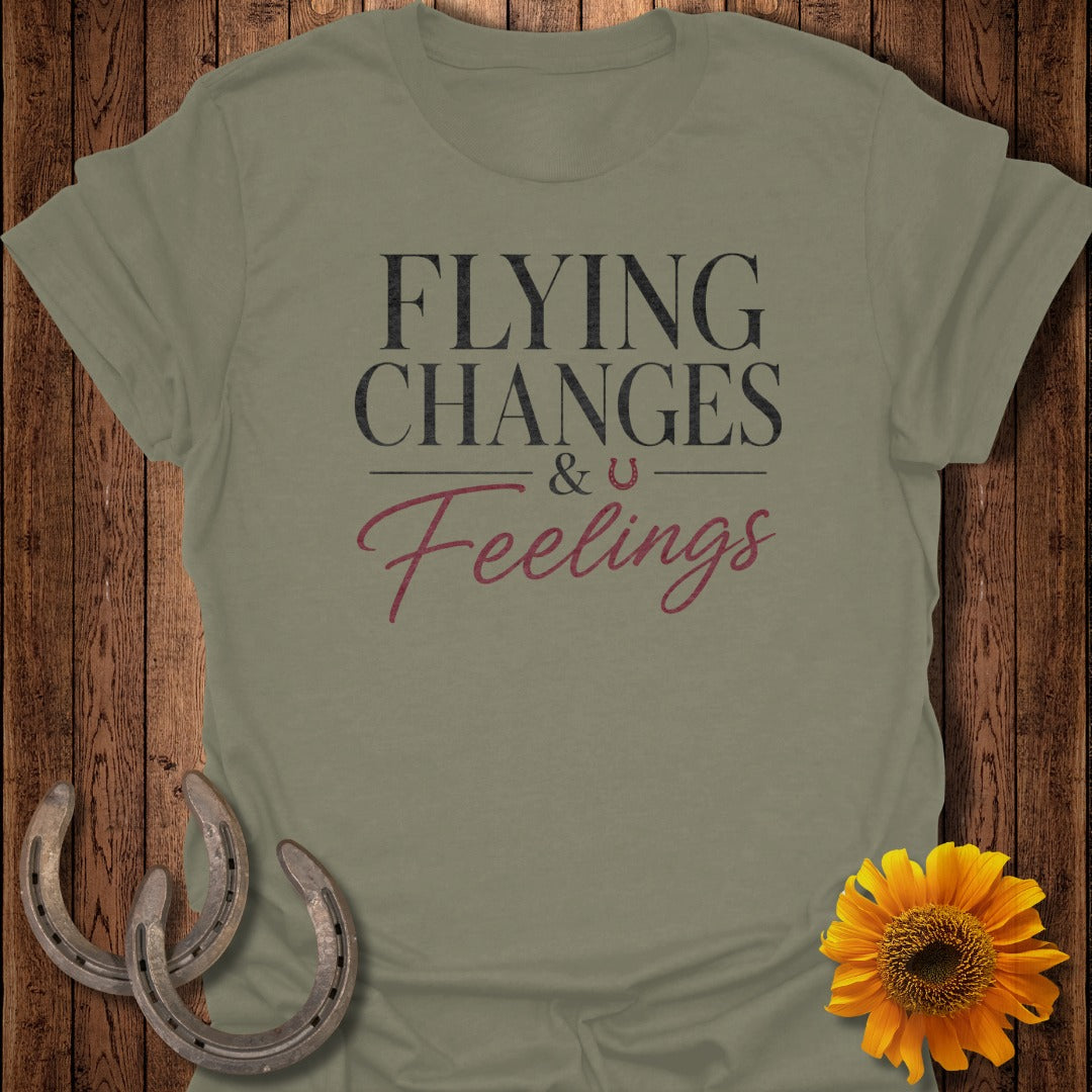 Olive t-shirt with text "FLYING CHANGES & U Feelings" and horseshoes.