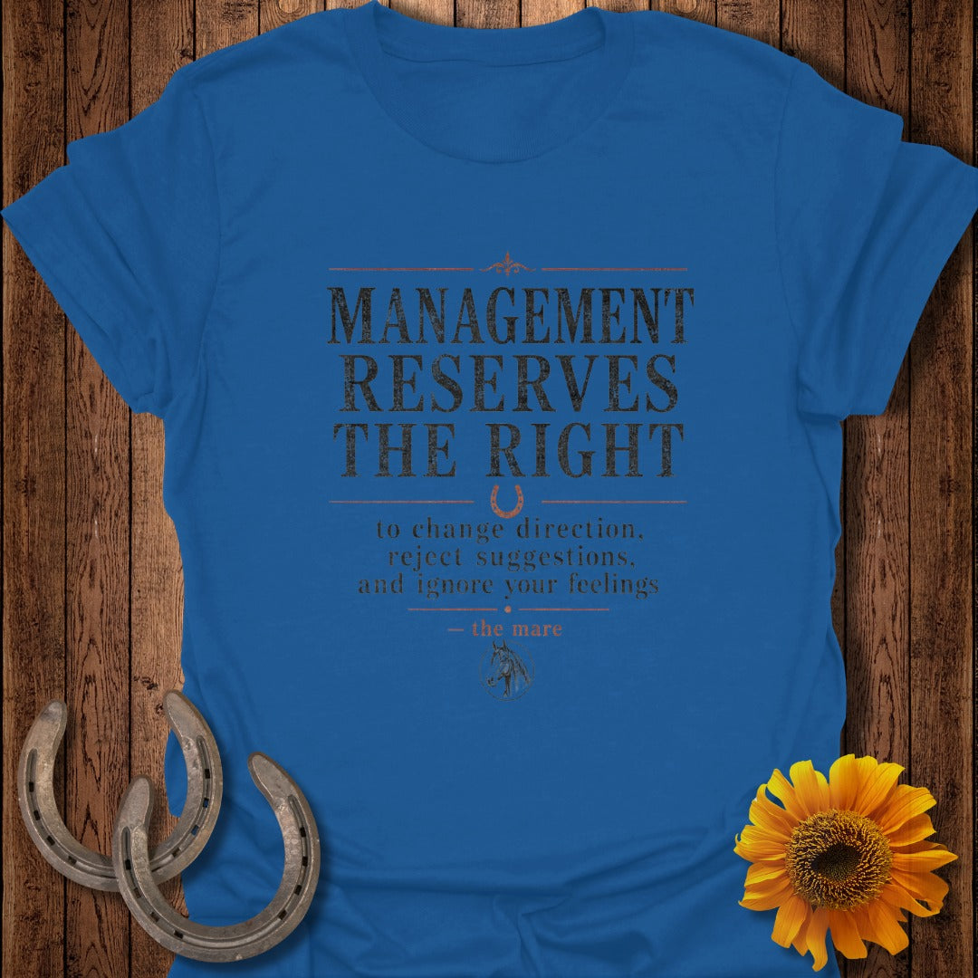 Blue t-shirt with "Management Reserves The Right to change direction, reject suggestions, and ignore your feelings — the mare" text.