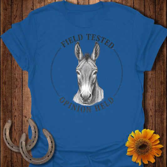 Blue t-shirt with a drawing of a donkey's head and the text "FIELD TESTED OPINION HELD".