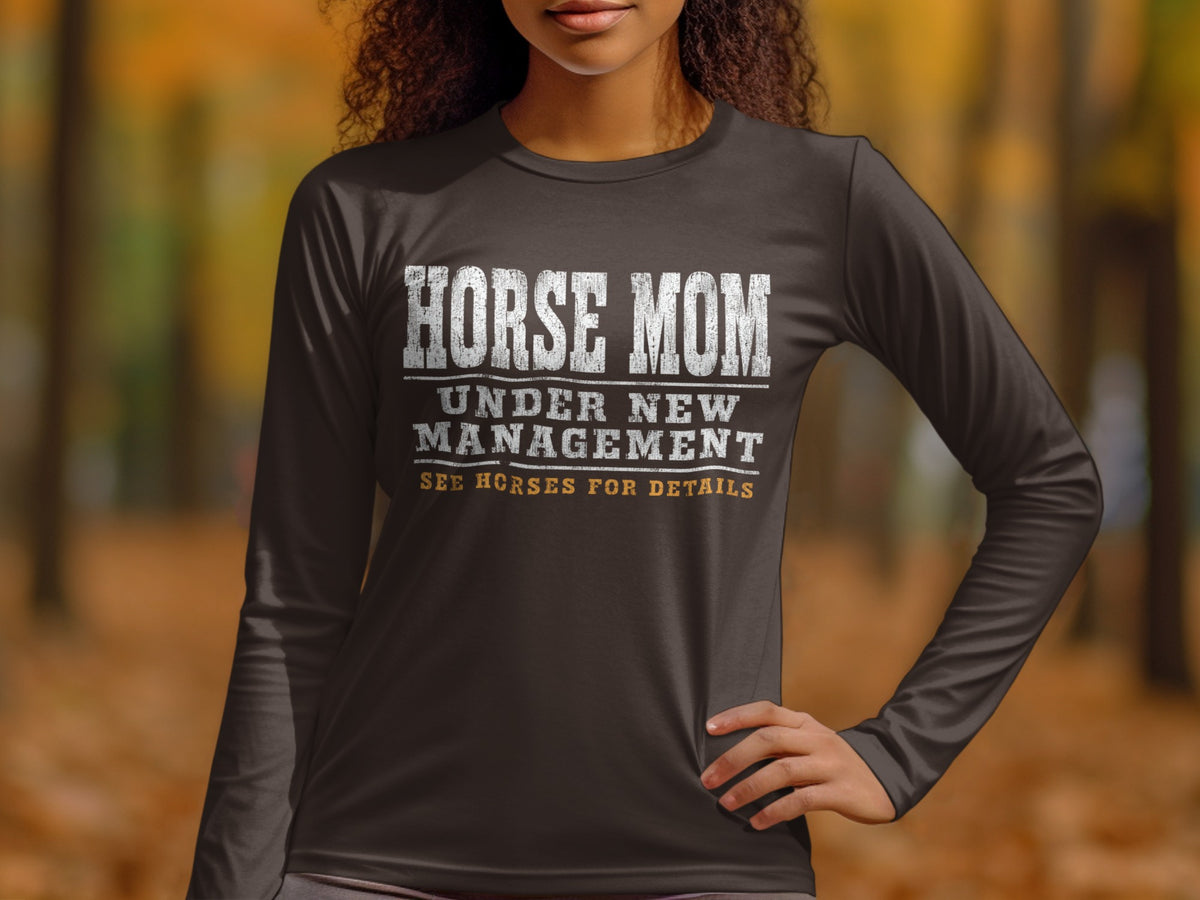 Dark long-sleeve shirt with "HORSE MOM UNDER NEW MANAGEMENT SEE HORSES FOR DETAILS" text.