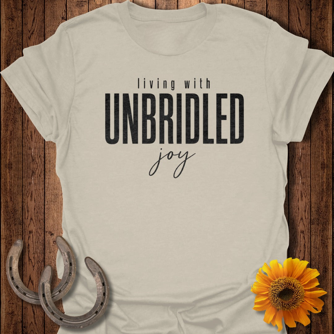 Cream t-shirt with "living with unbridled joy" text, horseshoes, and sunflower.