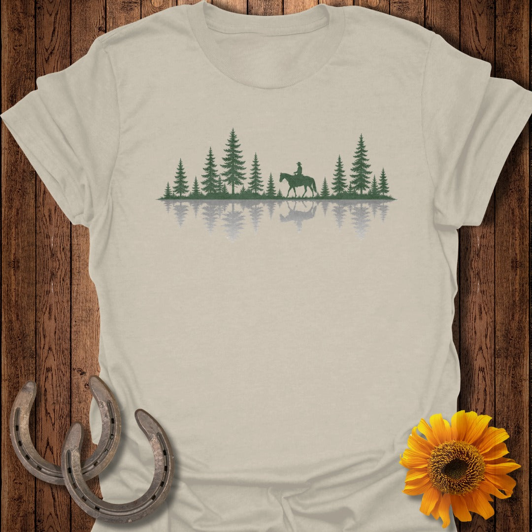 T-shirt featuring a forest and rider reflected in water.