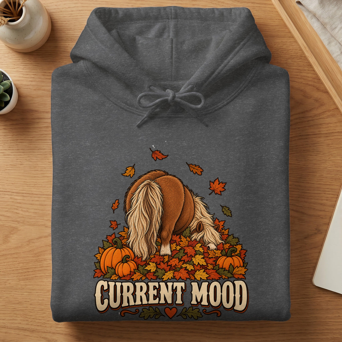 Dark gray hoodie with a brown pony, pumpkins, and autumn leaves graphic and "CURRENT MOOD" text.