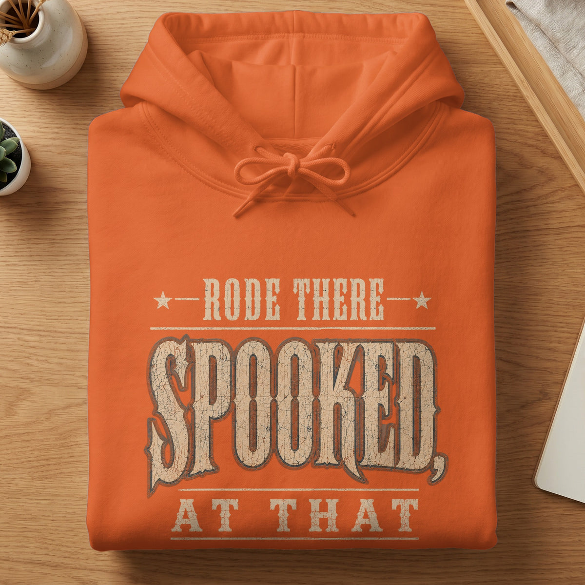 Orange hoodie with "Rode There, Spooked, At That" text and distressed font.