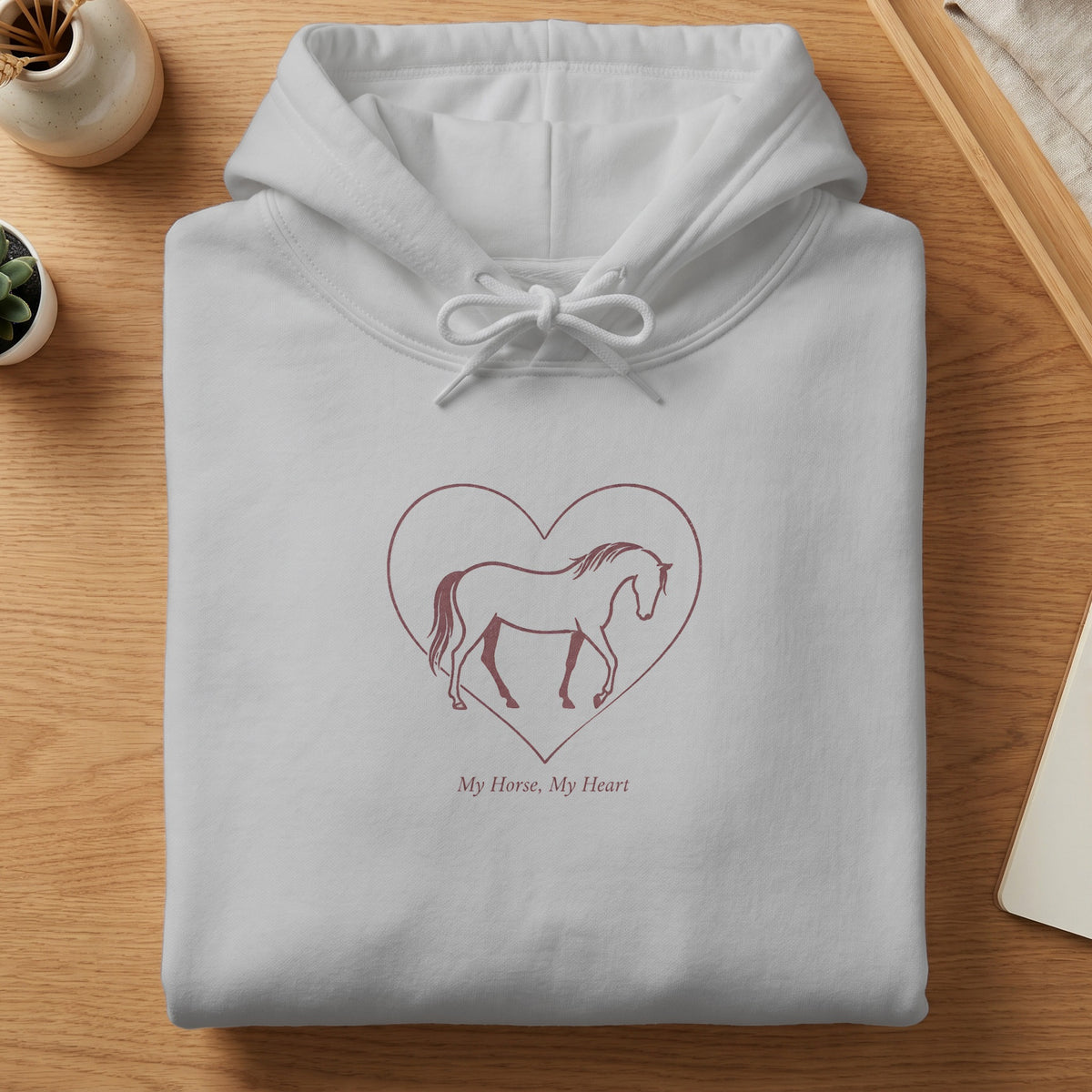 White hoodie with a horse silhouette inside a heart and text.