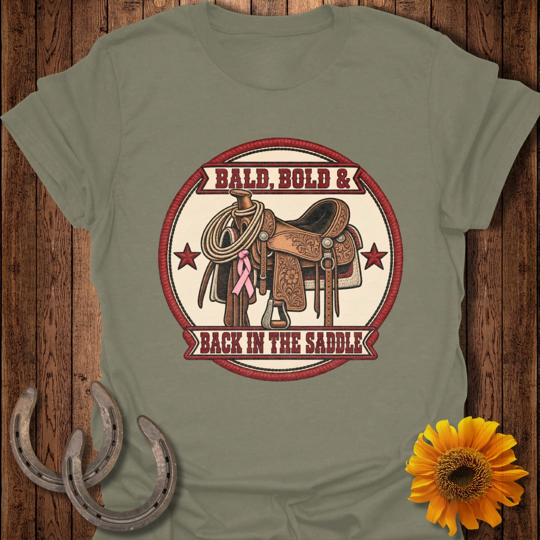 Saddle with rope, pink ribbon, and text "Bald, Bold & Back In The Saddle".