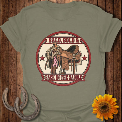 Saddle with rope, pink ribbon, and text "Bald, Bold & Back In The Saddle".
