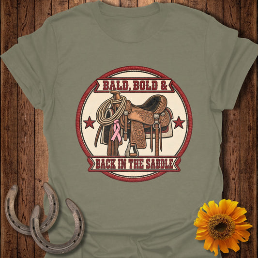 Saddle with rope, pink ribbon, and text "Bald, Bold & Back In The Saddle".