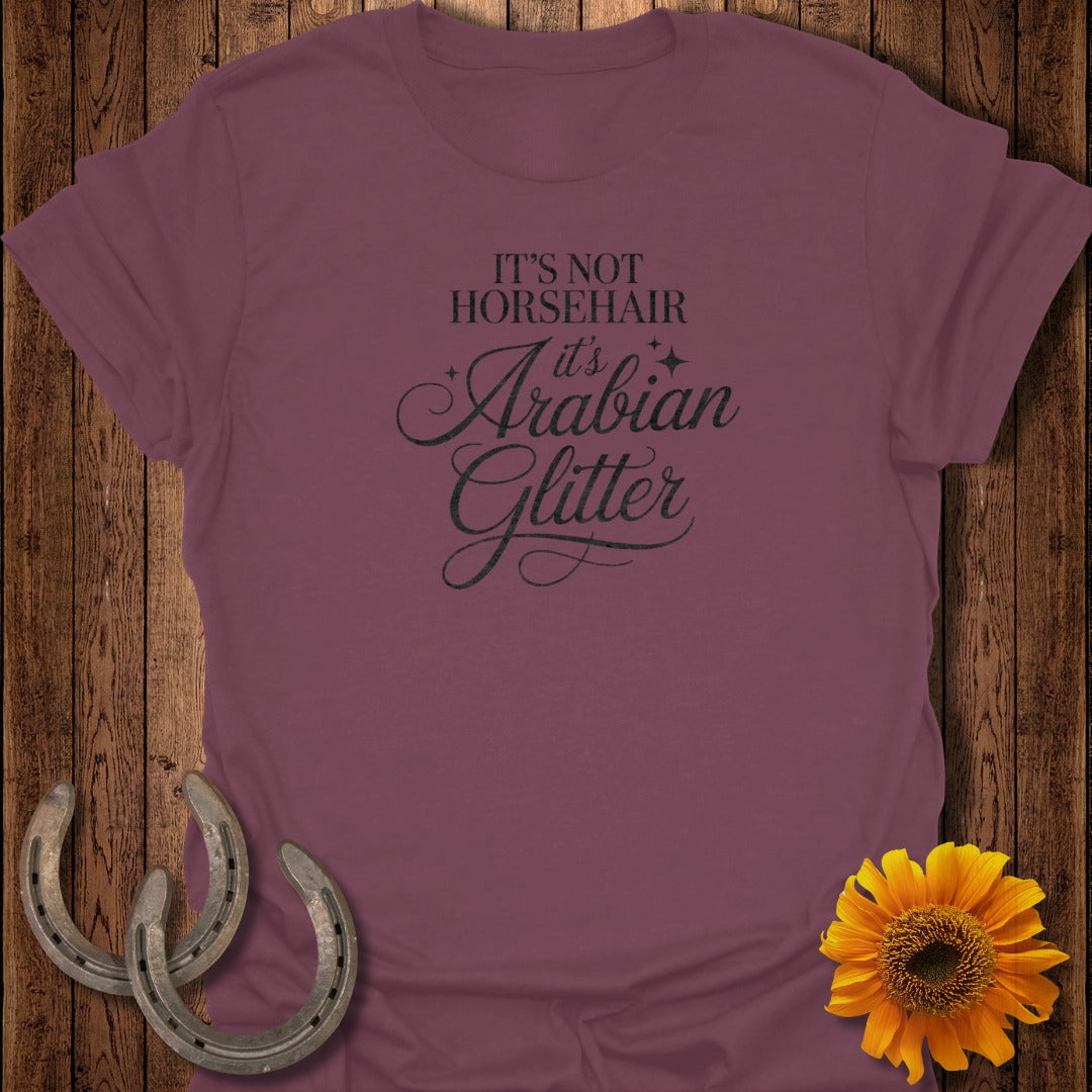 Maroon t-shirt with "IT'S NOT ARABIAN it's Glitter" text and horseshoes and sunflower.