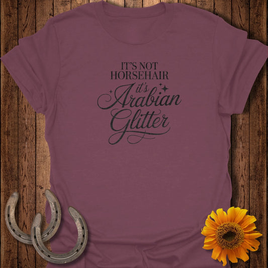 Maroon t-shirt with "IT'S NOT ARABIAN it's Glitter" text and horseshoes and sunflower.