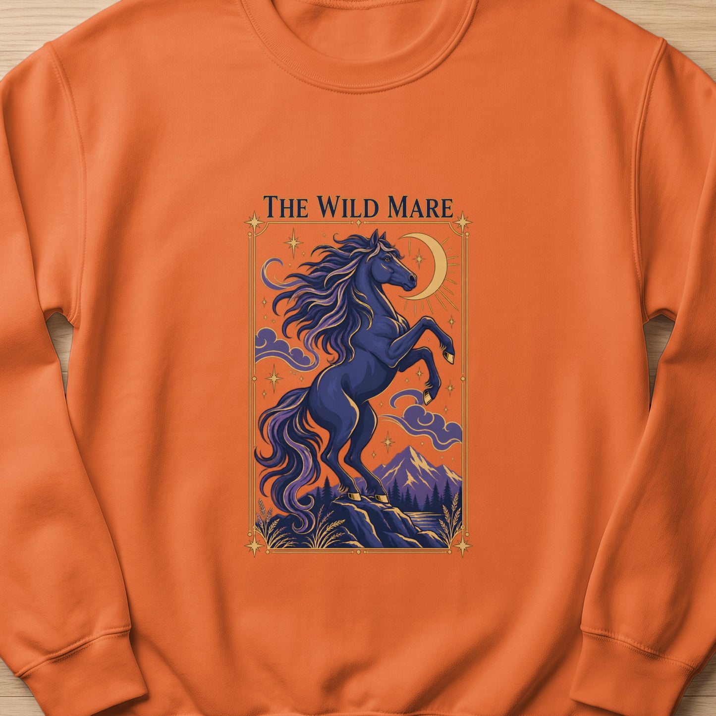 The Wild Mare text above dark blue horse rearing on rocks under crescent moon and starry sky.