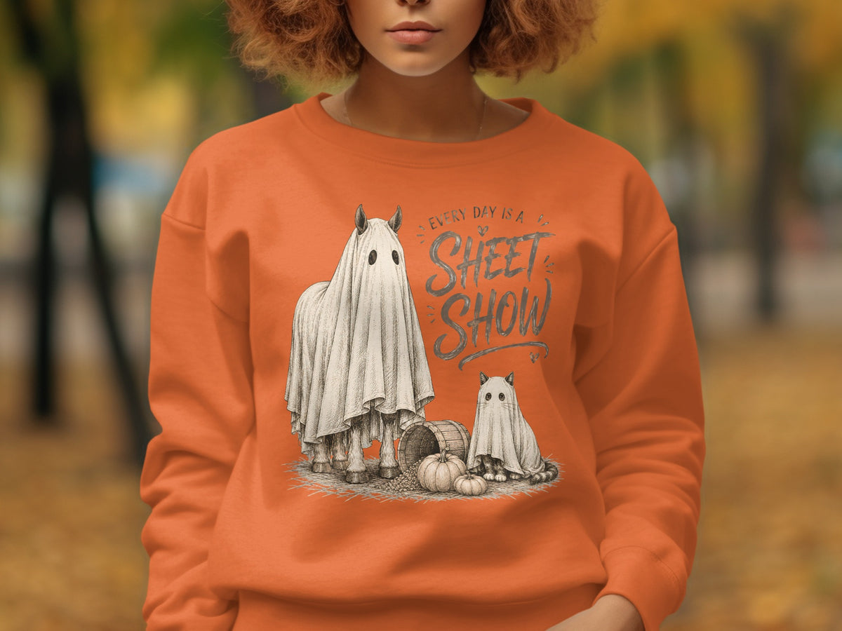 Orange sweatshirt with "Every Day is a Sheet Show" text and ghost horse and cat design.