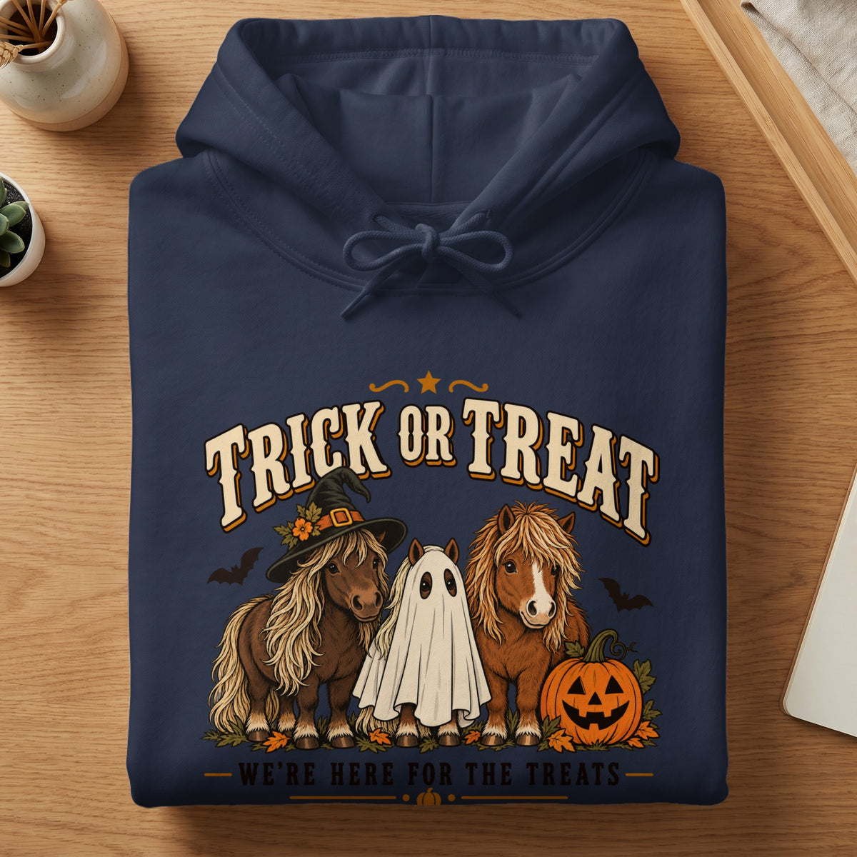 Navy hoodie with "Trick or Treat" text and ponies dressed for Halloween.