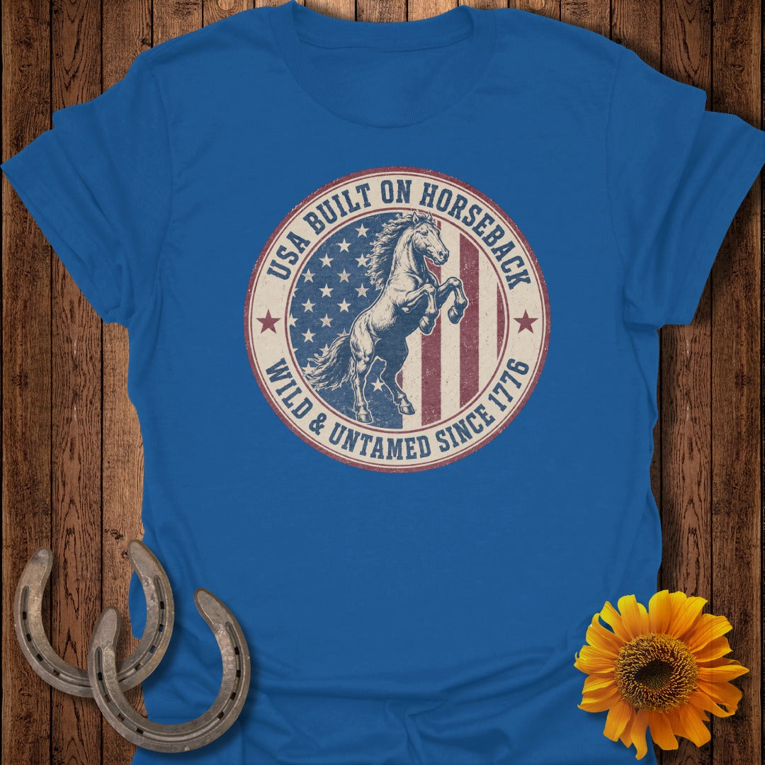 Blue t-shirt with "USA Built On Horseback Wild & Untamed Since 1776" graphic.