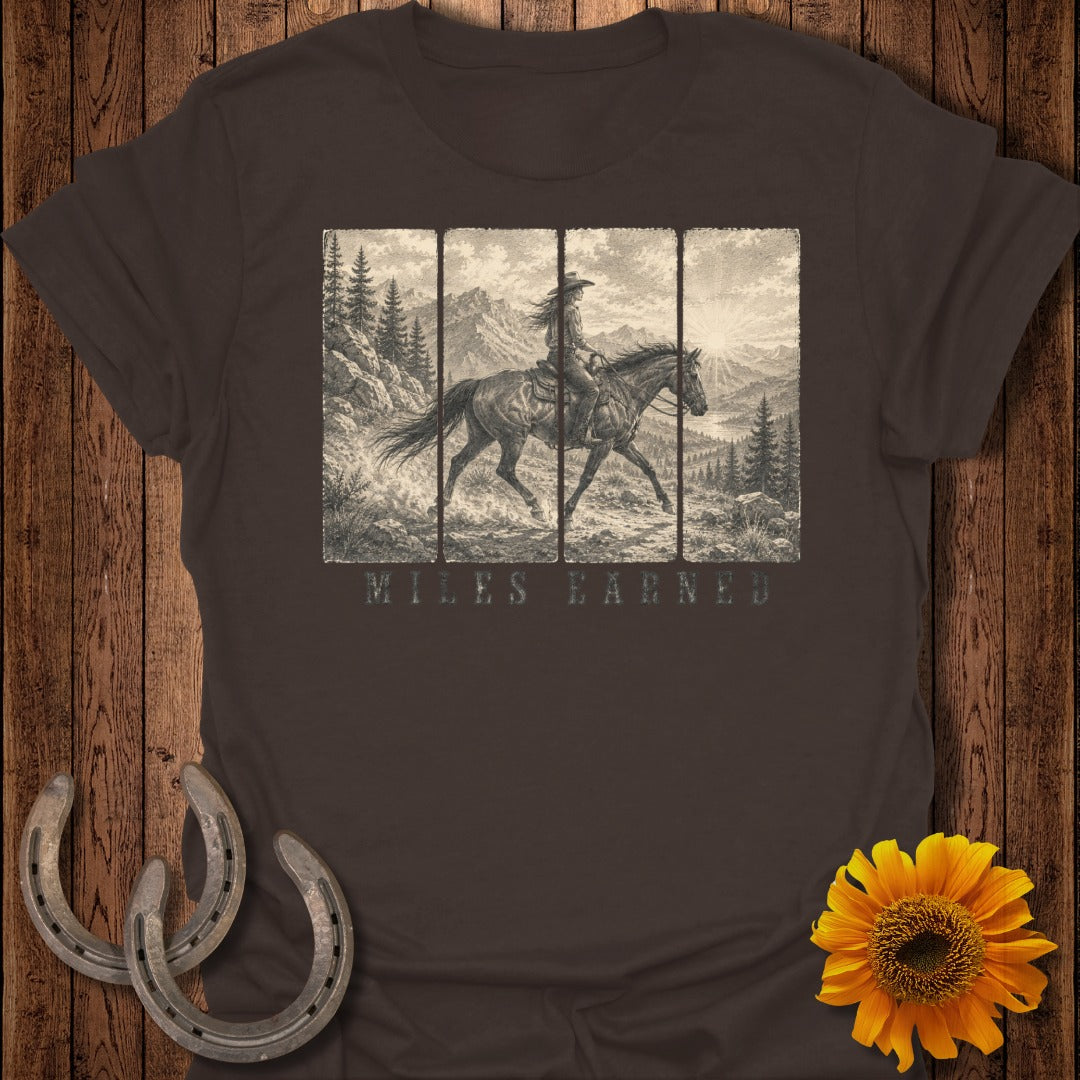 Brown t-shirt with vintage cowboy riding horse illustration and "MILES EARNED" text.