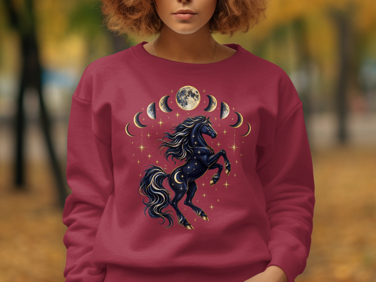 Maroon sweatshirt with a black unicorn, moon phases, and stars graphic.