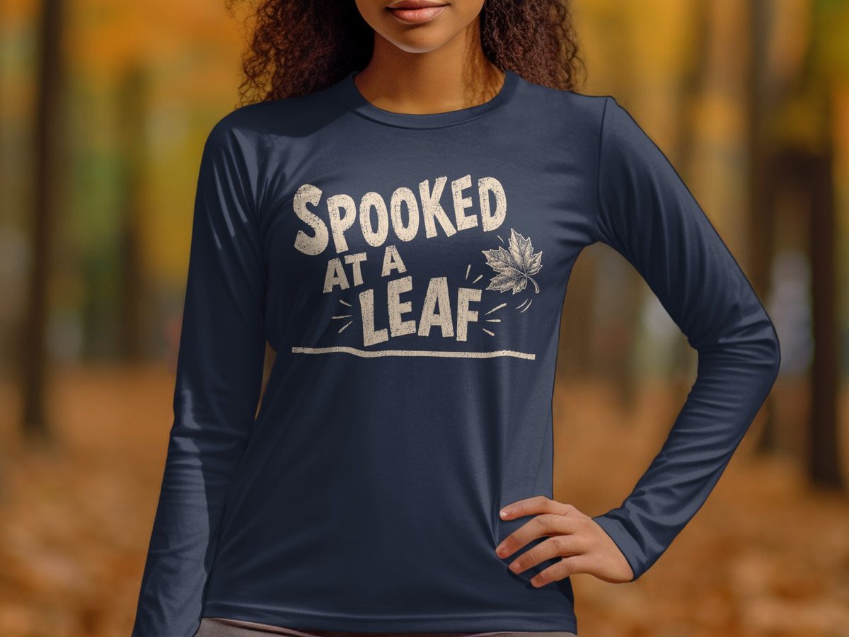 Dark blue long-sleeve shirt with "Spooked at a Leaf" and autumn leaf graphic.