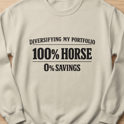 Cream sweatshirt with black text reading "Diversifying my portfolio 100% horse 0% savings."