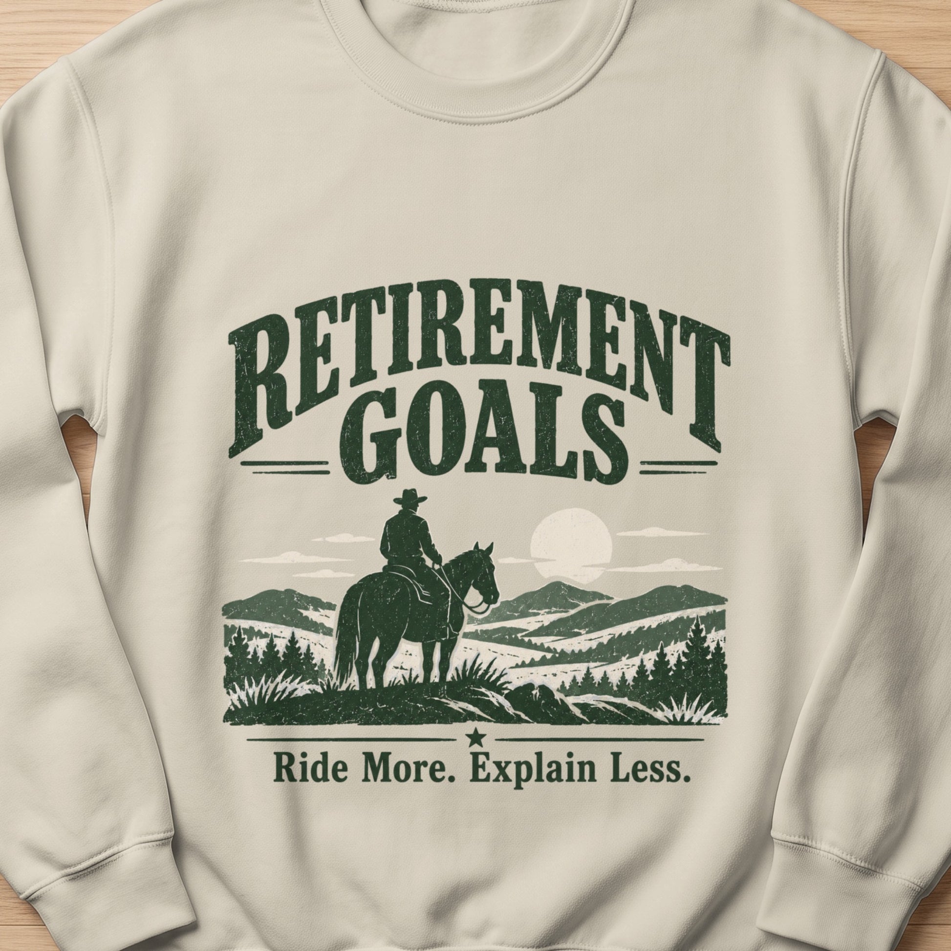 Cream sweatshirt with "Retirement Goals" and cowboy on horseback graphic.