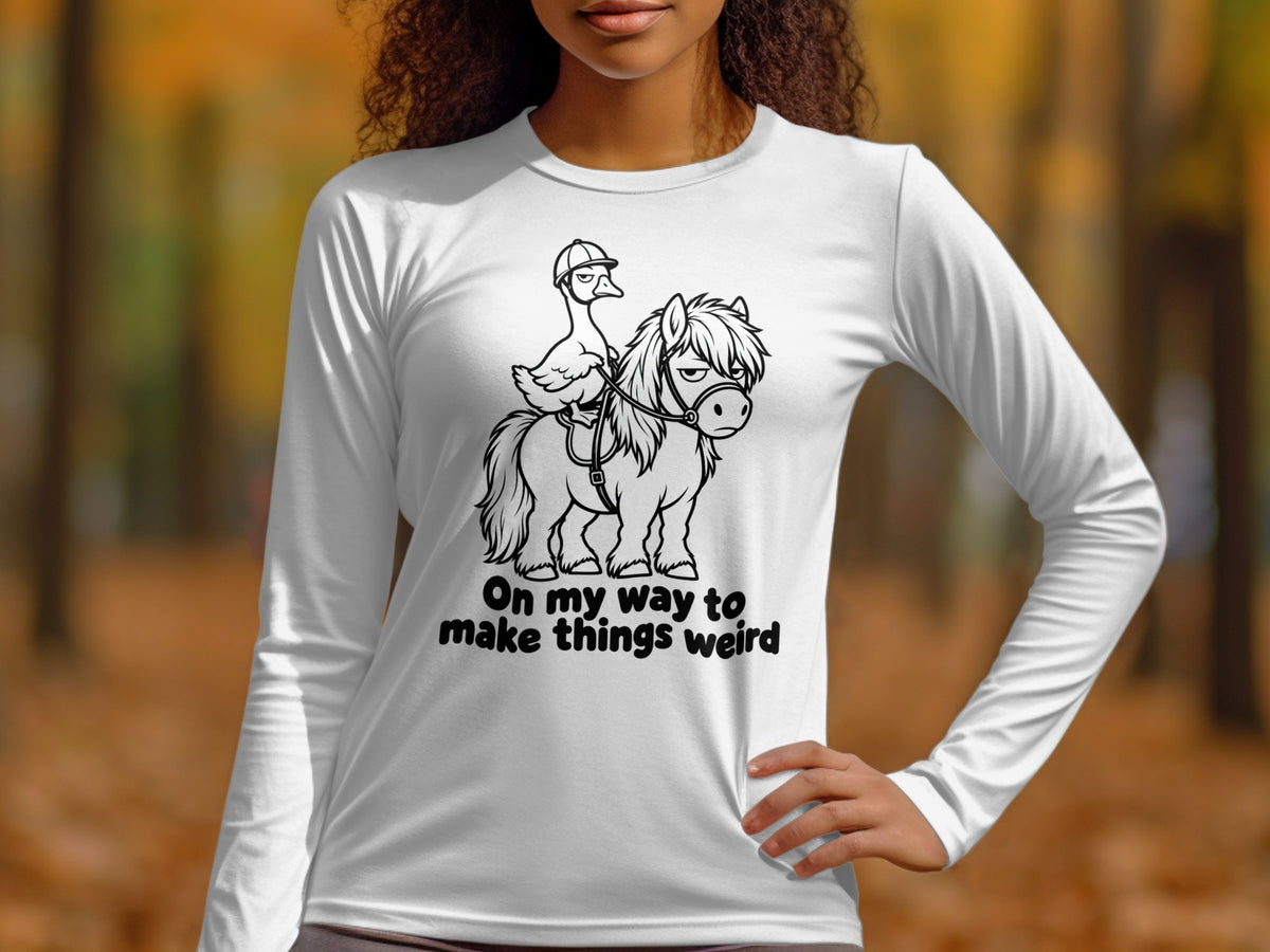 White long sleeve shirt with a graphic of a duck riding a pony and text "On my way to make things weird".
