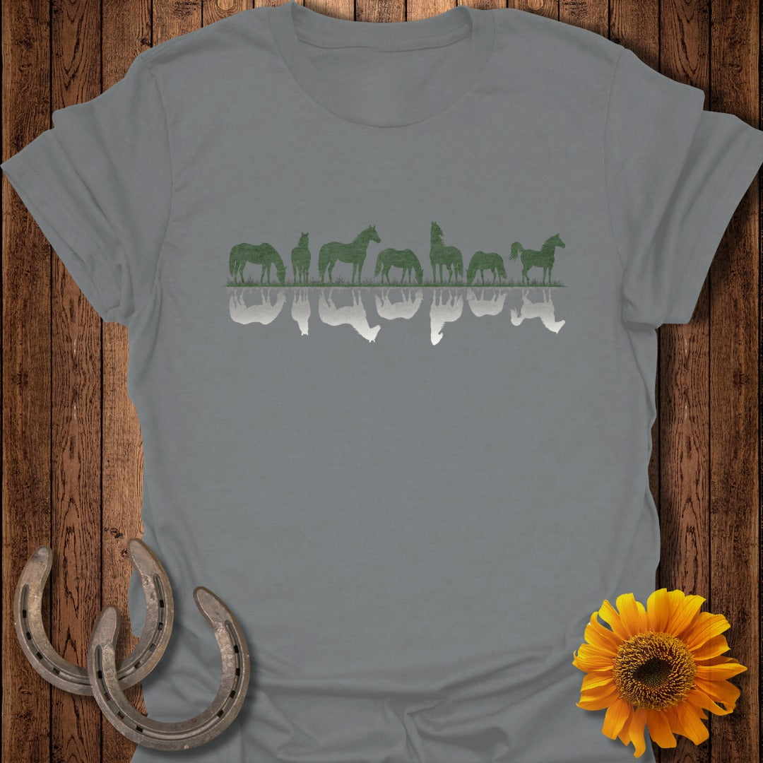 Silhouette of horses reflected in water, with horseshoes and sunflower.