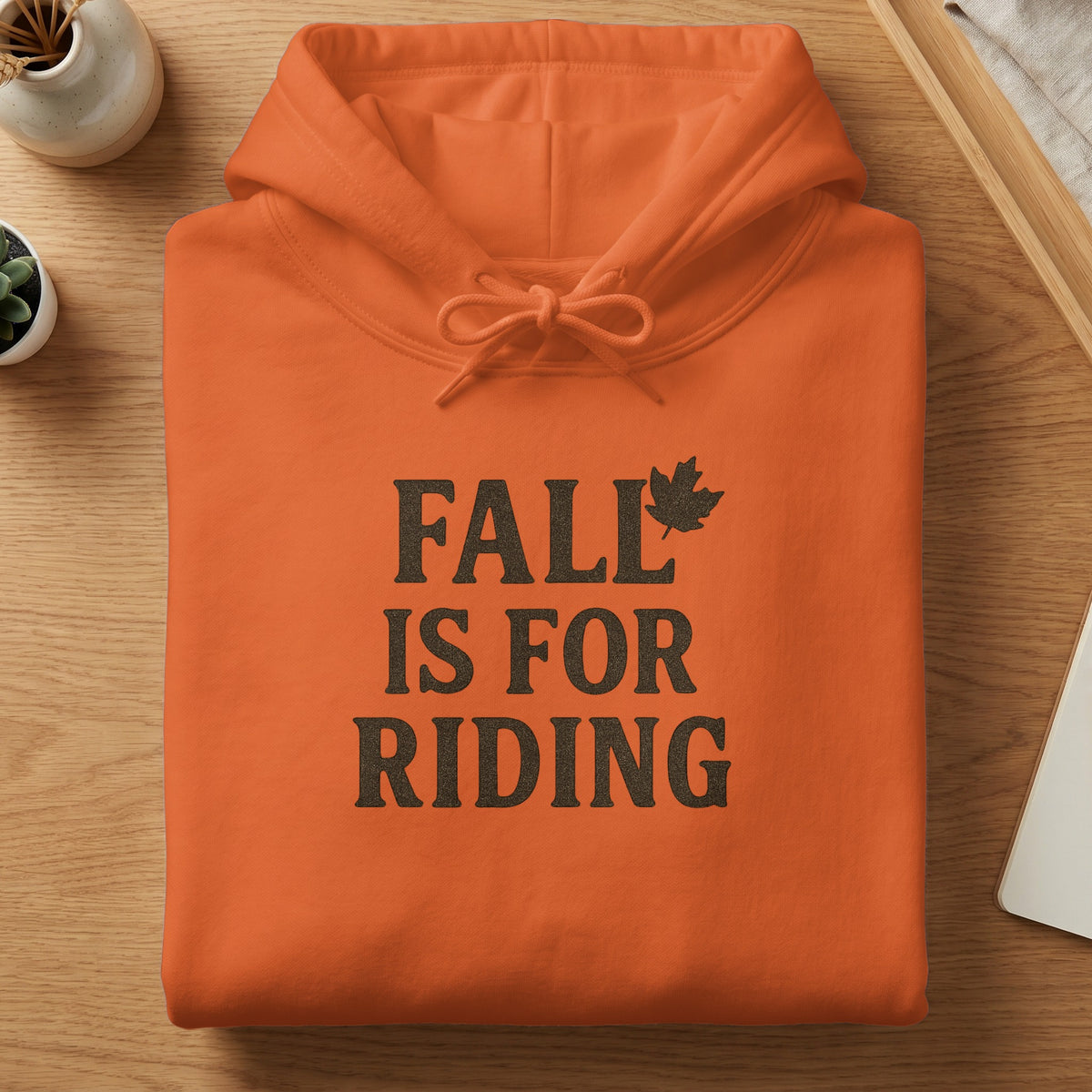 Orange hoodie with "FALL IS FOR RIDING" text and maple leaf graphic.