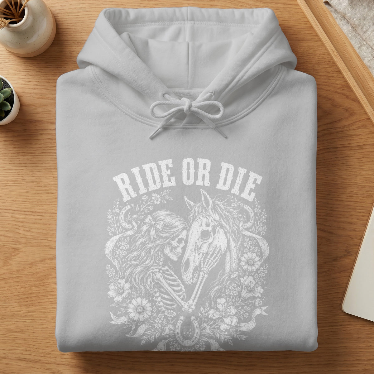 Gray hoodie with "RIDE OR DIE" text and skeleton with horse graphic.