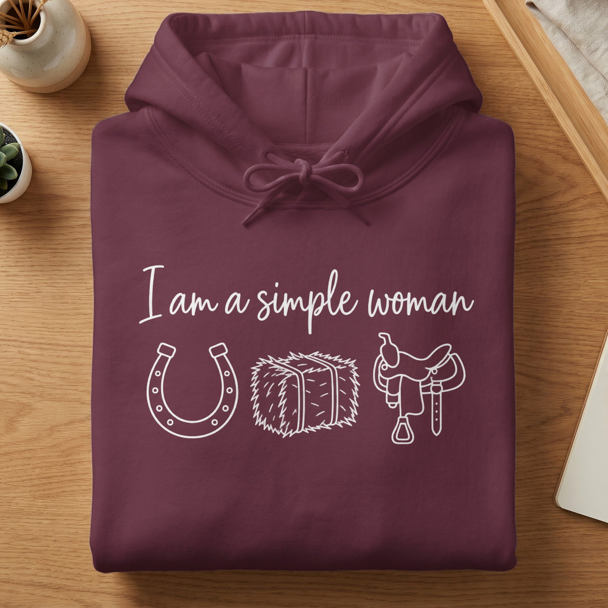 Maroon hoodie with "I am a simple woman" text, horseshoe, hay bale, and saddle graphic.