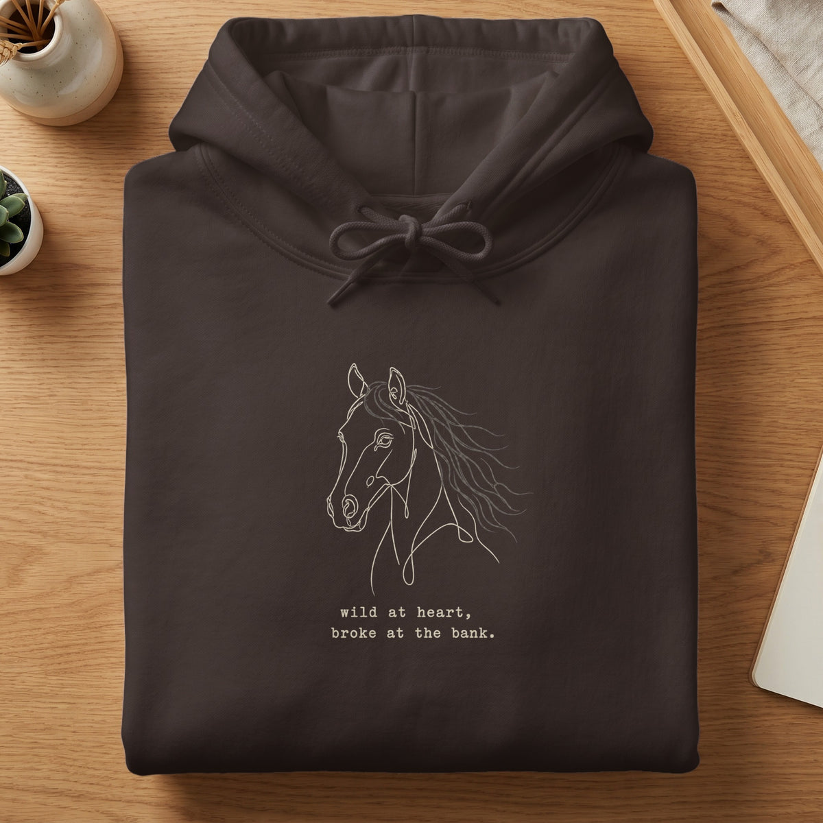 Brown hoodie with a white line drawing of a horse and text.
