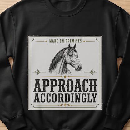 Black sweatshirt with a horse illustration and text "MARE ON PREMISES APPROACH ACCORDINGLY".