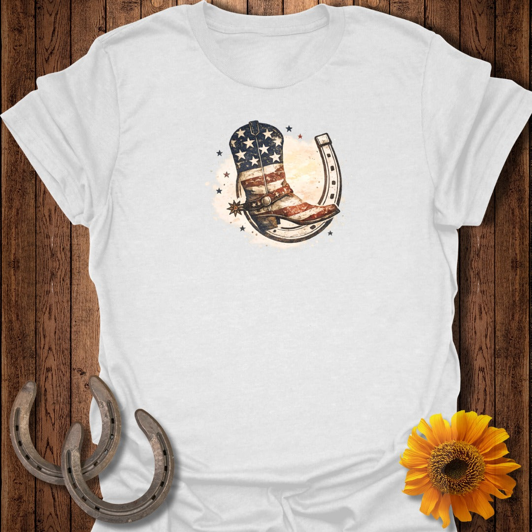 White t-shirt with patriotic cowboy boot and horseshoe graphic.