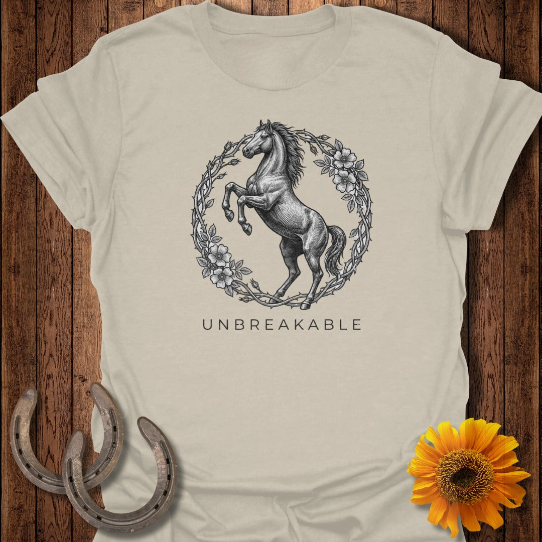 T-shirt with horse and floral wreath graphic and "UNBREAKABLE" text.