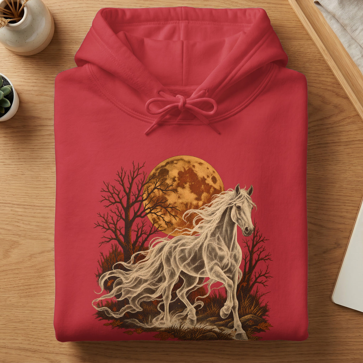 Red hoodie with a ghostly white horse running through a spooky forest under a large moon.