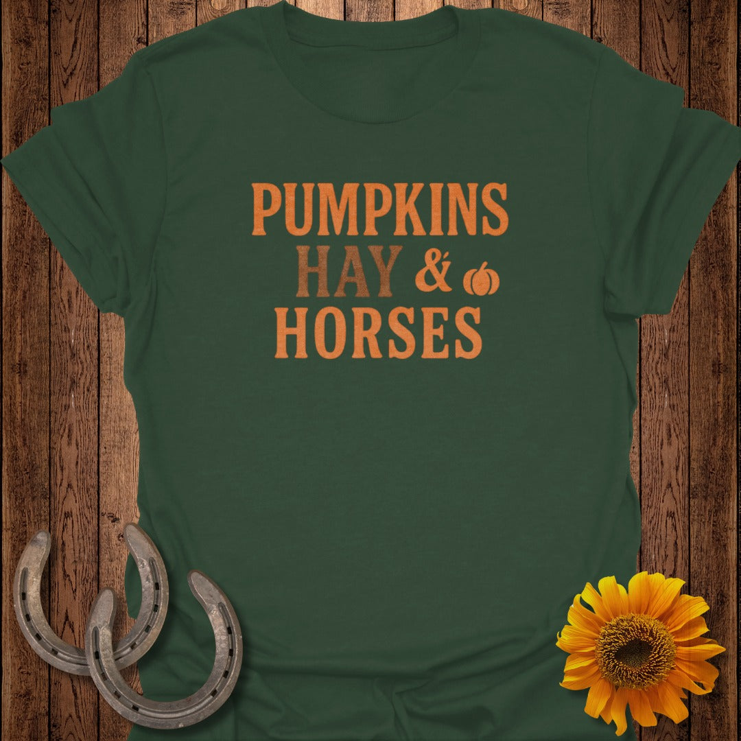 Dark green t-shirt with "Pumpkins Hay & Horses" text and autumn decorations.