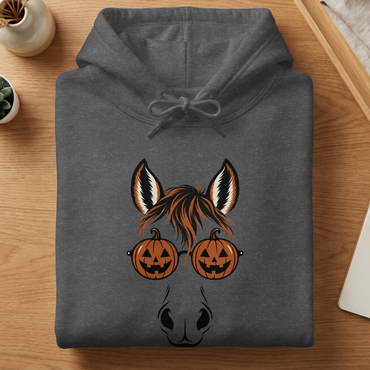 Dark gray hoodie with a graphic of a horse's face wearing pumpkin glasses.