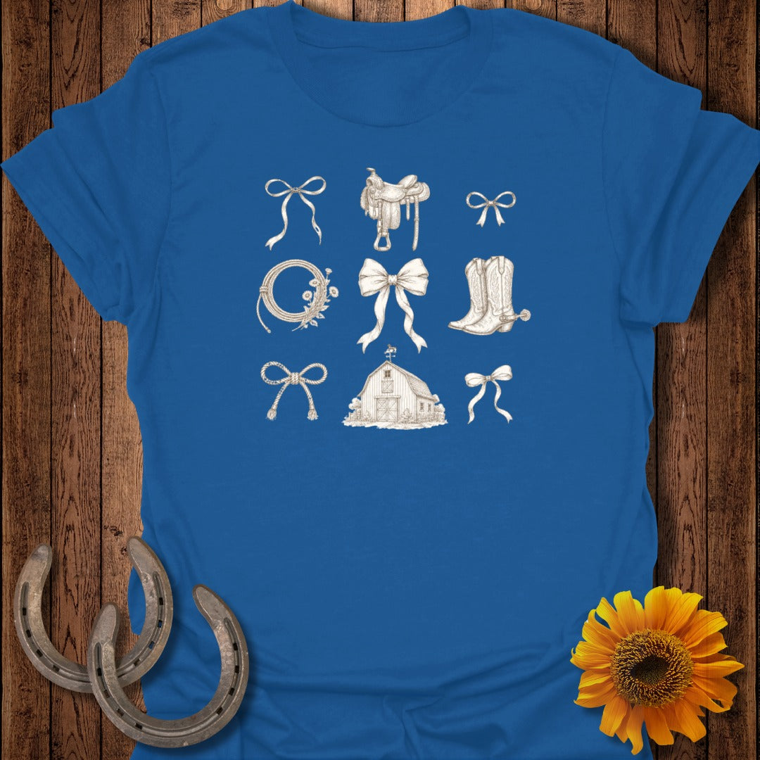 Blue t-shirt with sepia-toned drawings of western-themed items: saddles, bows, barn, horseshoes.