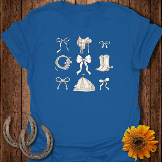 Blue t-shirt with sepia-toned drawings of western-themed items: saddles, bows, barn, horseshoes.