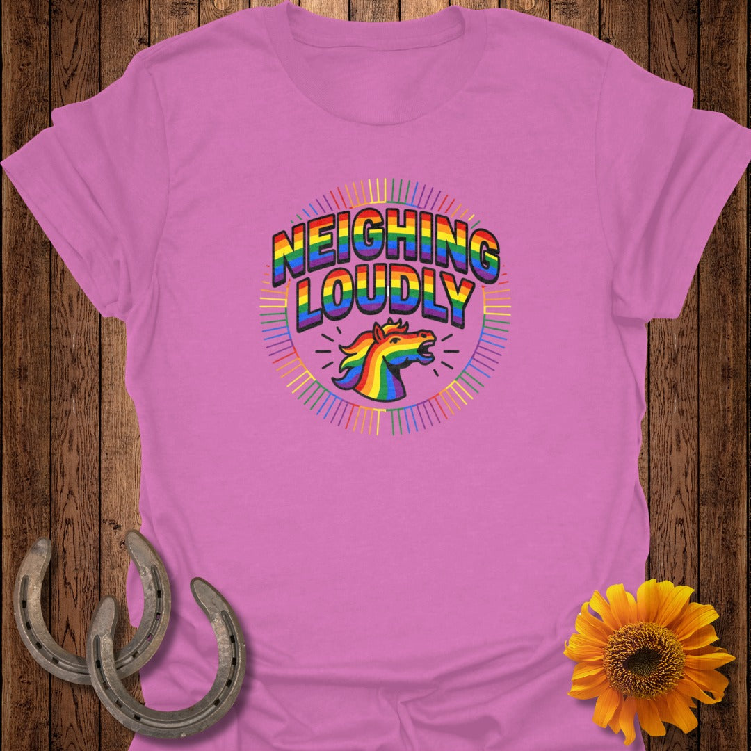 Pink t-shirt with rainbow "Neighing Loudly" unicorn graphic.