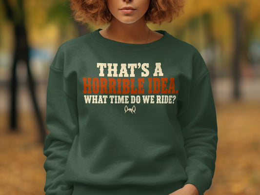 Green sweatshirt with "That's a horrible idea. What time do we ride?" text and graphic.