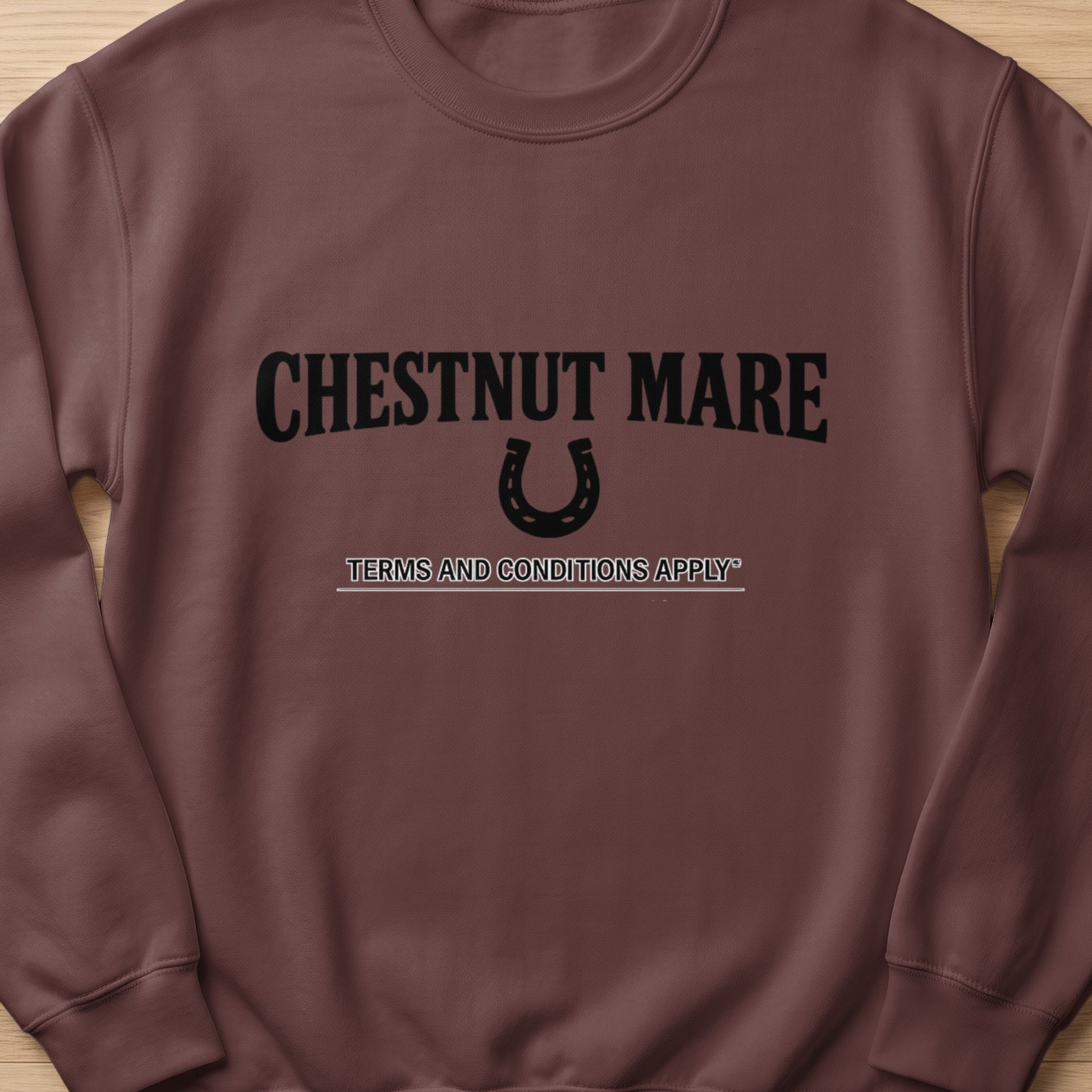 Brown sweatshirt with "CHESTNUT MARE" text, a horseshoe, and "TERMS AND CONDITIONS APPLY" text.