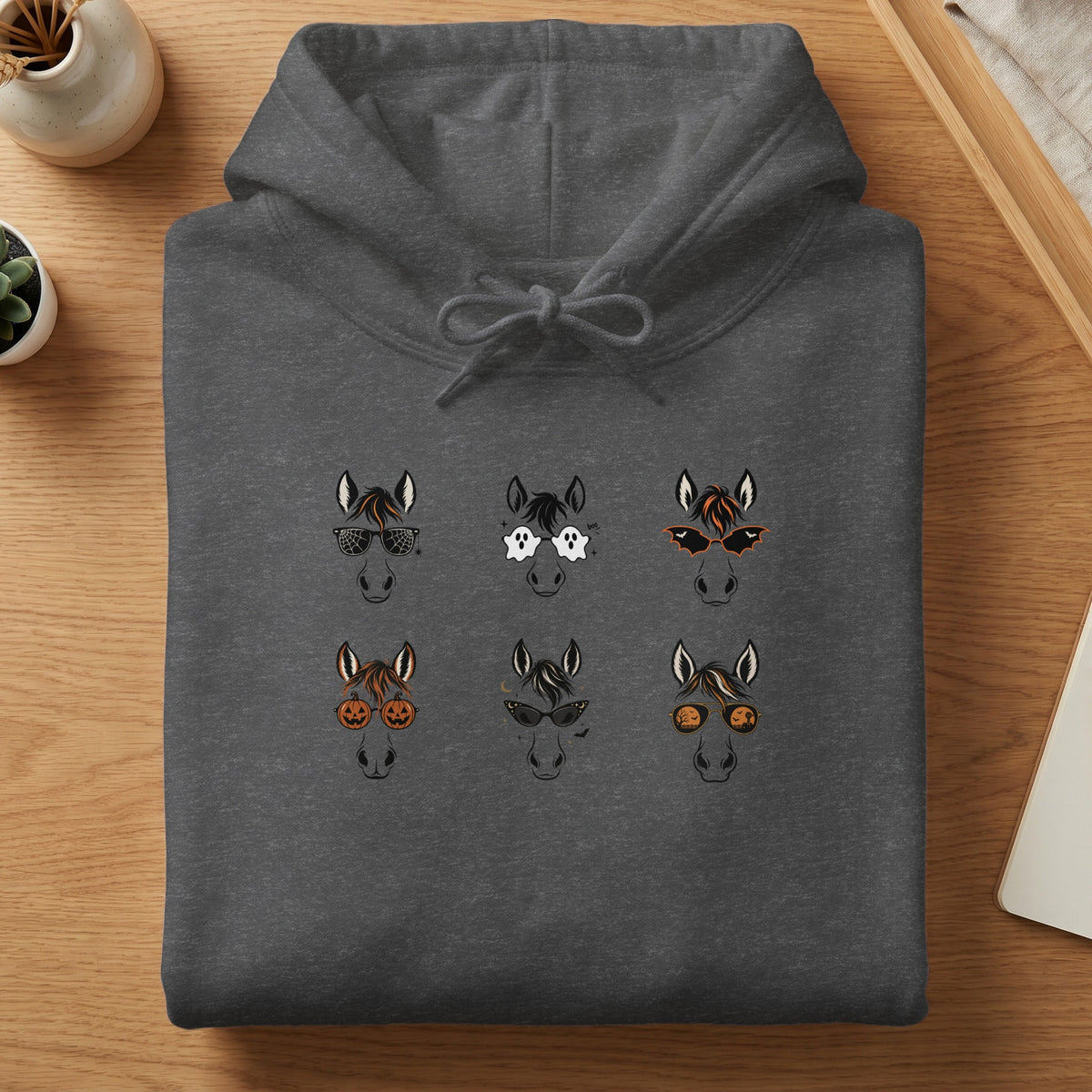 Dark gray hoodie with six cartoon horse heads wearing Halloween-themed sunglasses.