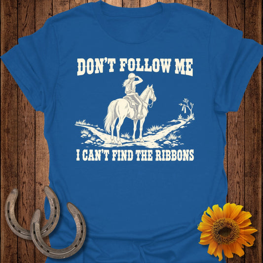 Blue t-shirt with white graphic of a rider on a horse and text "DON'T FOLLOW ME I CAN'T FIND THE RIBBONS".