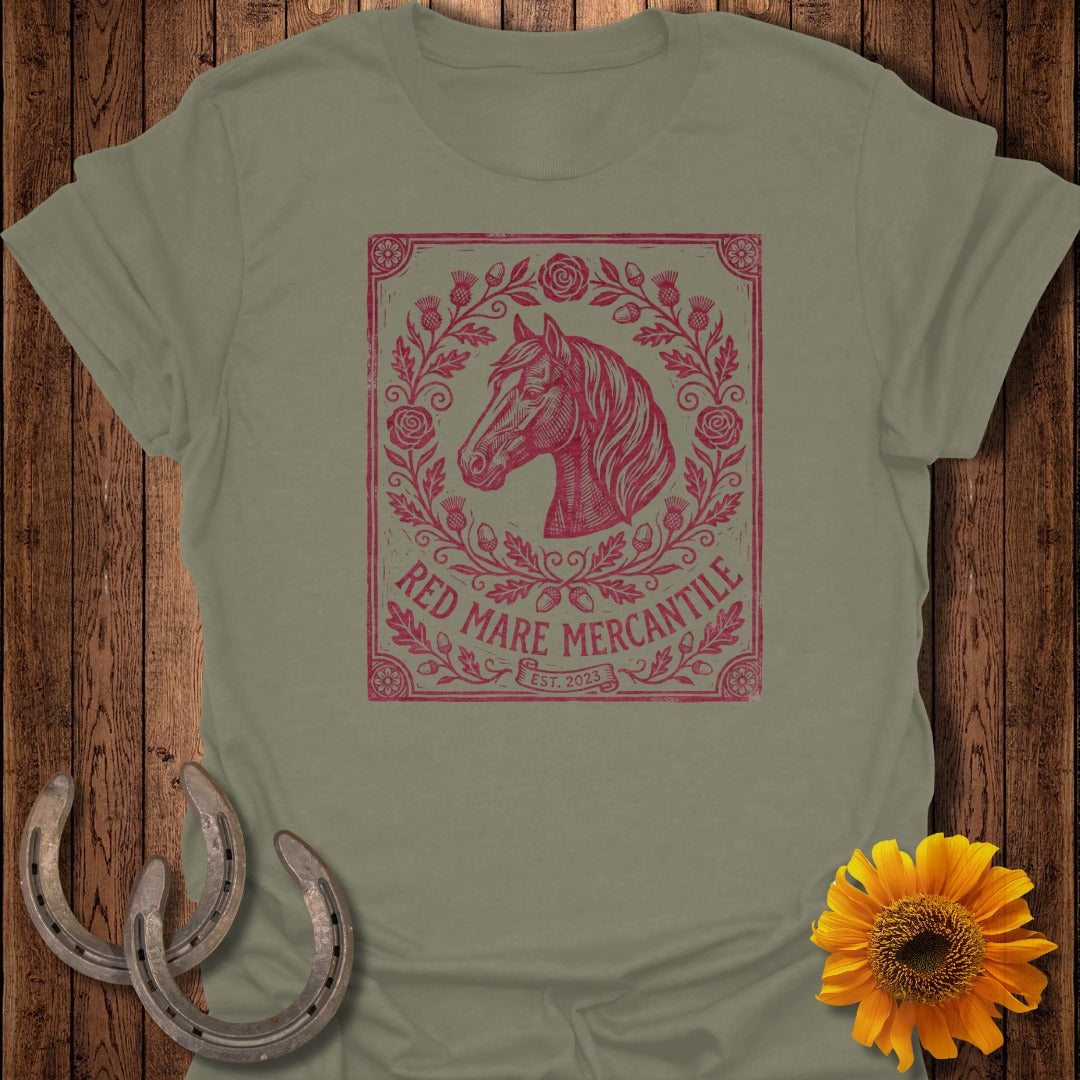 Olive green t-shirt with a distressed red graphic of a horse head in a floral wreath.
