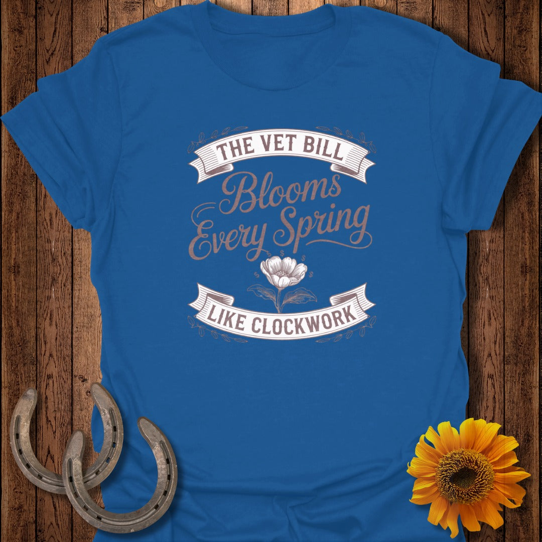 Blue t-shirt with text "The Vet Bill Blooms Every Spring Like Clockwork."