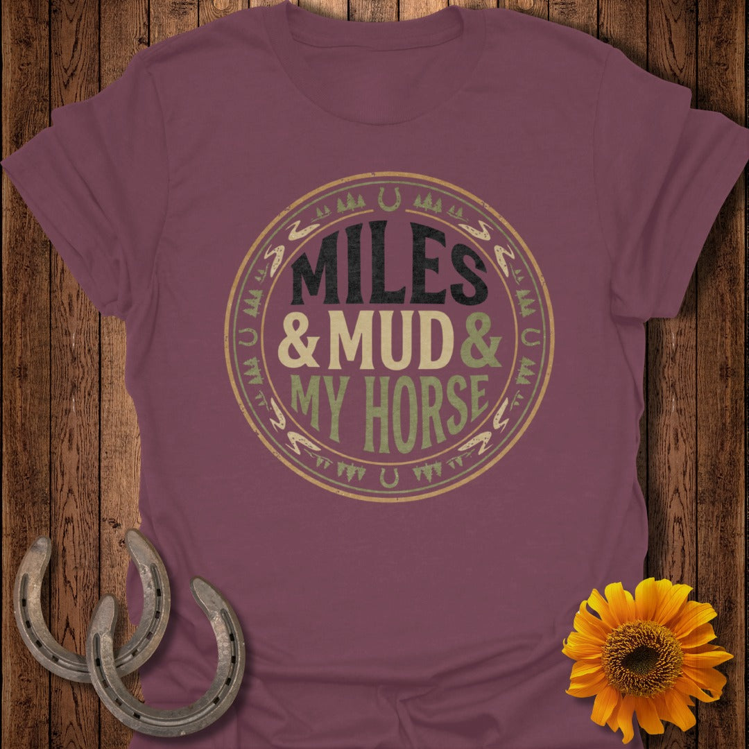 Burgundy t-shirt with "Miles & Mud & My Horse" text and horseshoe graphics.