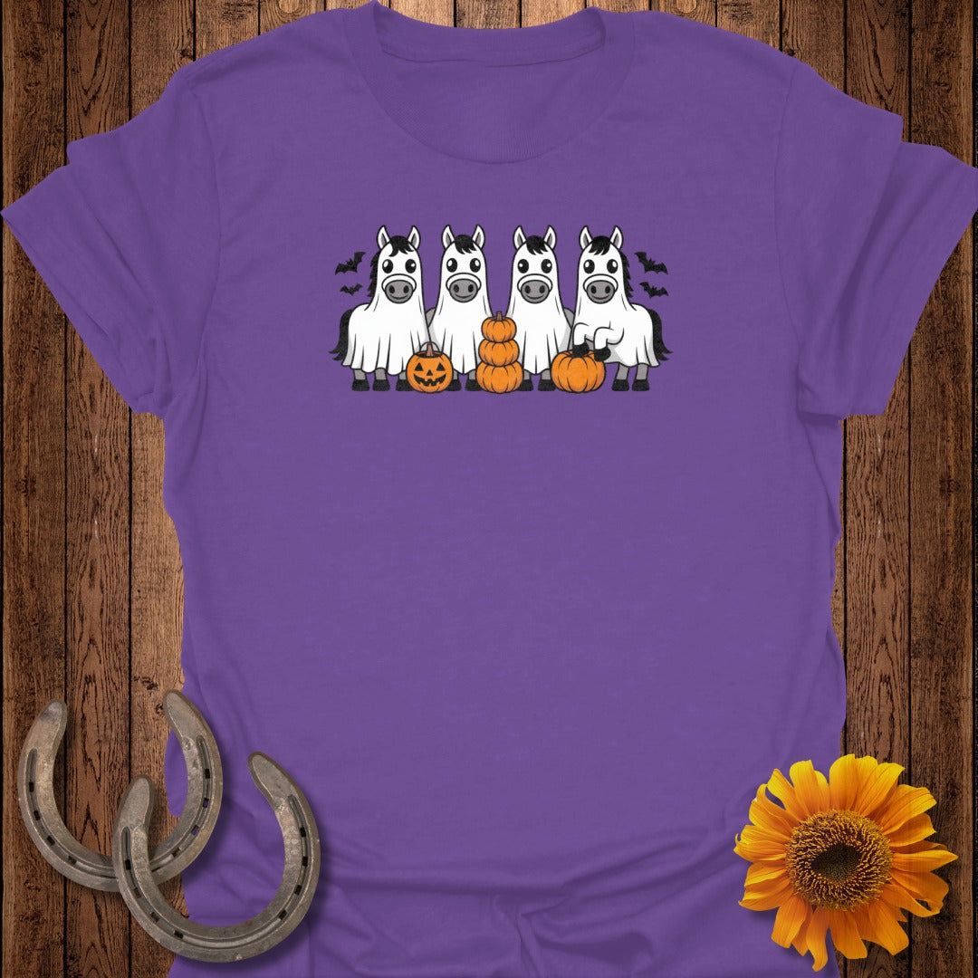 Four horses wearing ghost costumes with pumpkins and bats for Halloween.