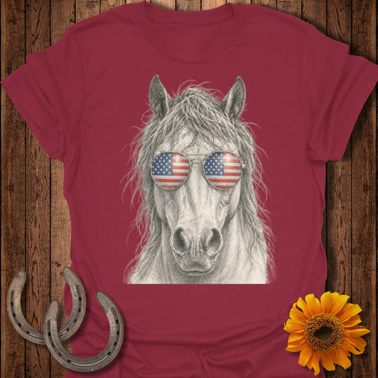 Horse wearing American flag sunglasses on a burgundy t-shirt.